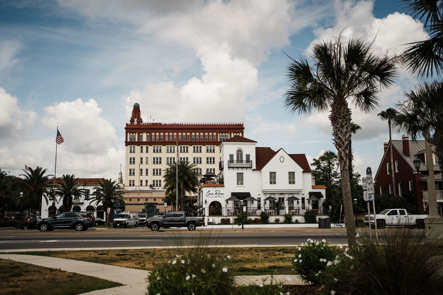 Charming overview of downtown architecture in St. Augustine with palm trees and blue sky.